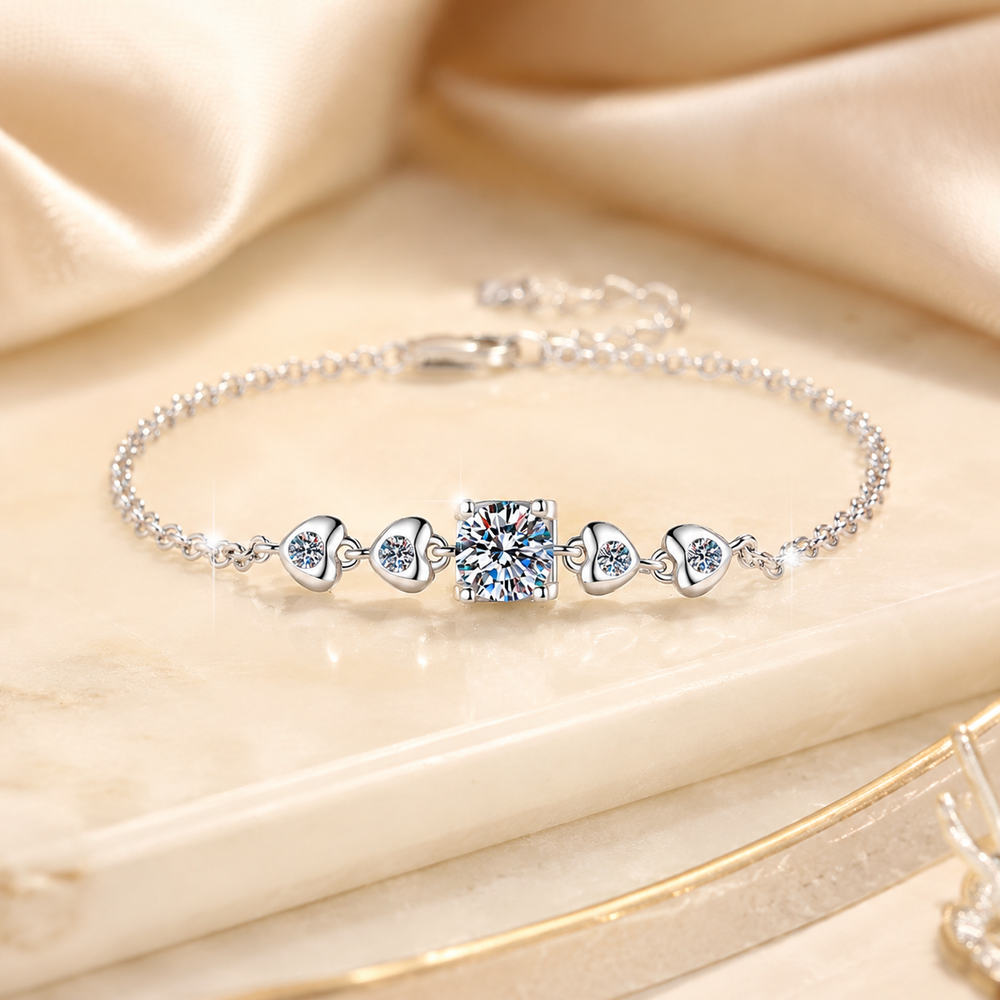 Amoura silver moissanite heart bracelet displayed on ivory marble