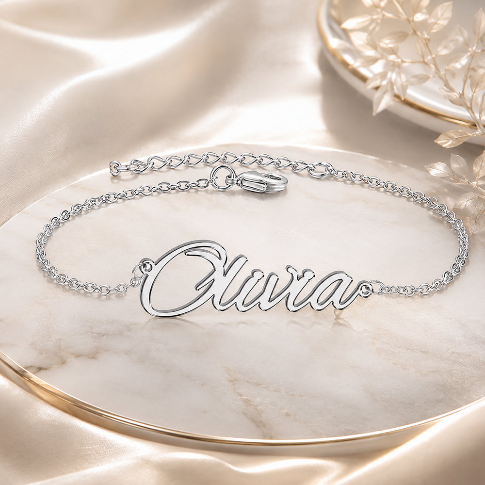 Personalized silver name bracelet on a luxury marble jewelry tray