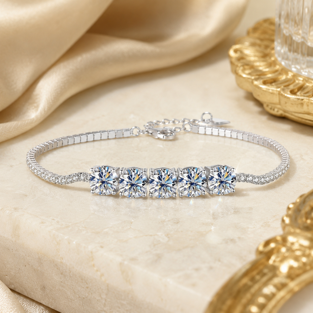 Close-up of five round brilliant moissanite stones in claw settings