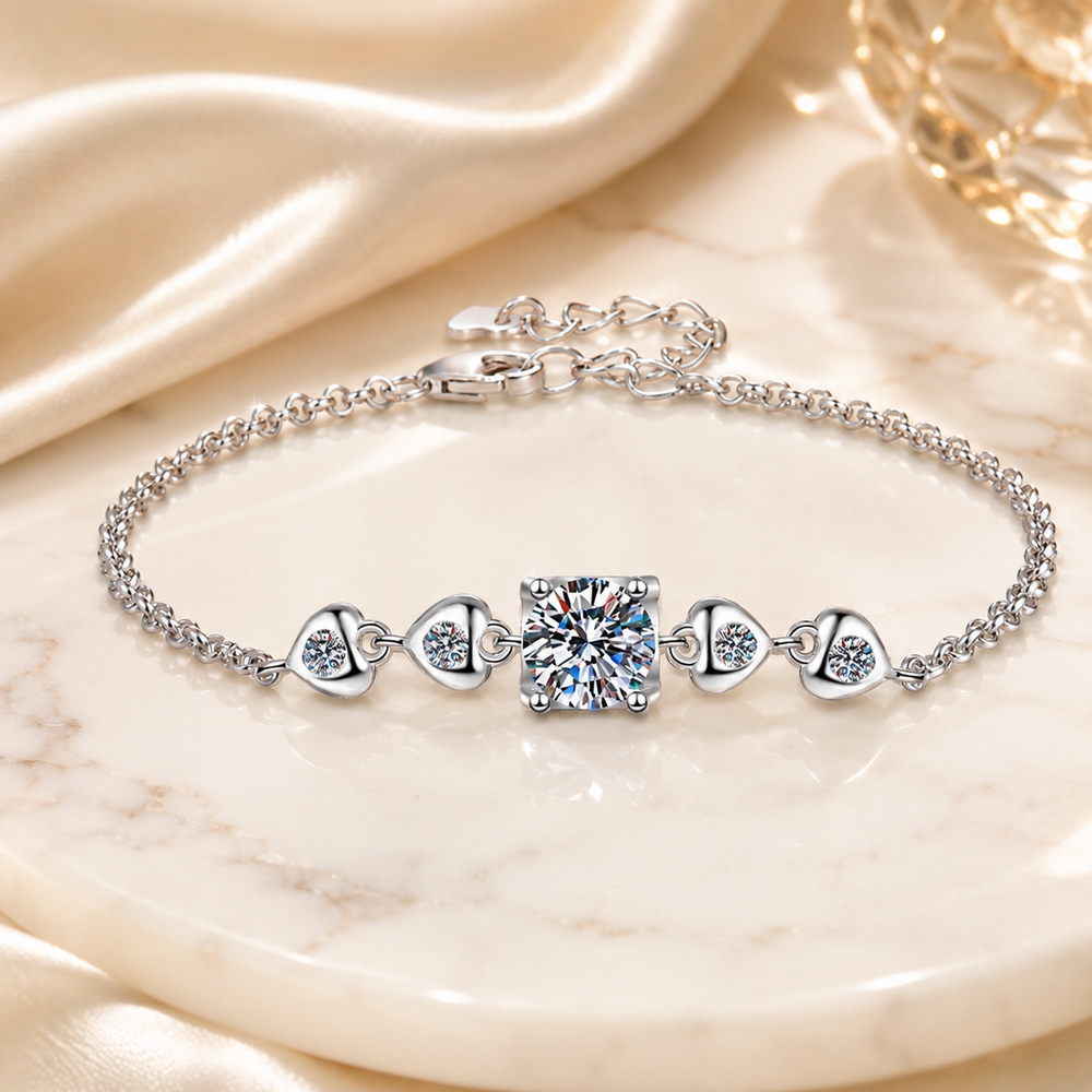 Close-up of one carat round moissanite and heart-shaped side links