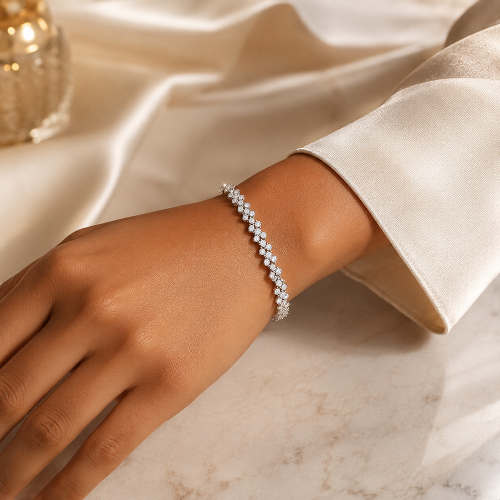 Woman wearing floral moissanite bracelet with ivory sleeve
