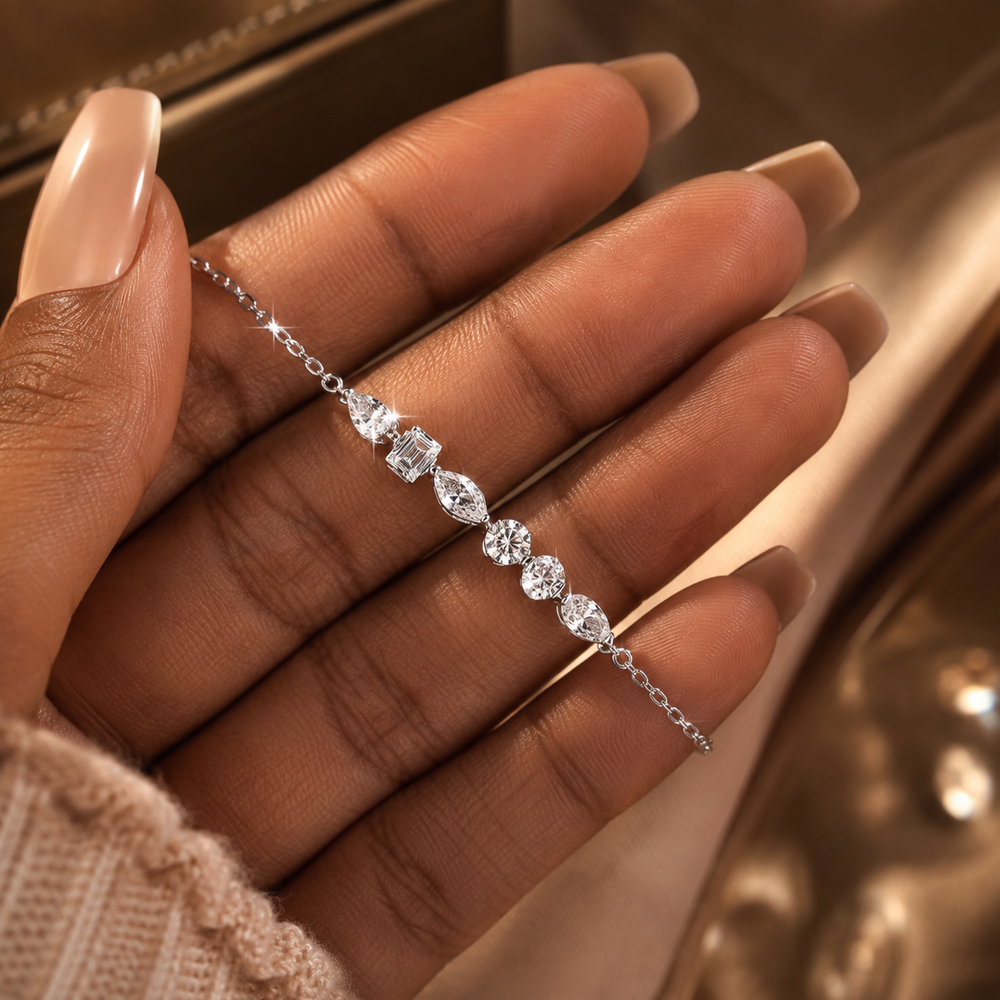 White gold-tone mixed-cut moissanite chain bracelet shown in hand