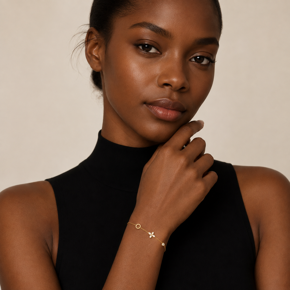 Woman wearing a delicate gold clover moissanite bracelet