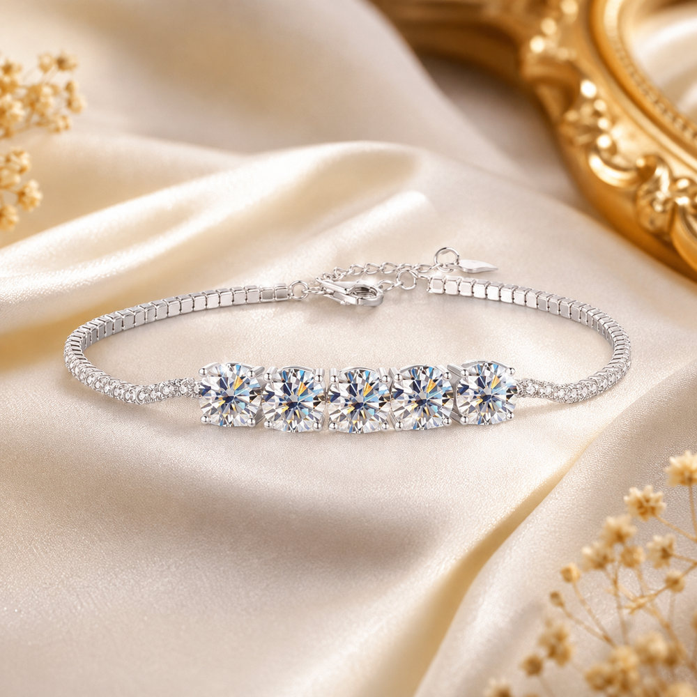 Quintessa five-stone moissanite bracelet displayed on champagne satin