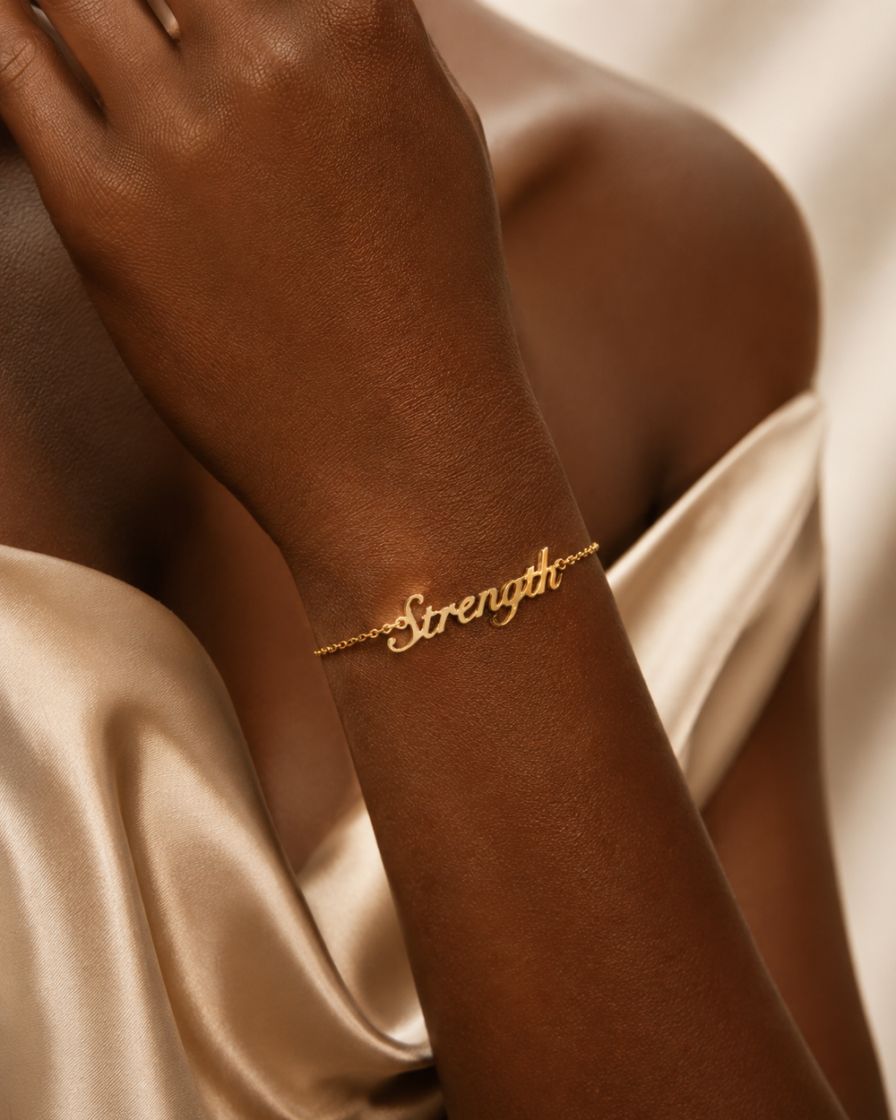 Close-up of personalized gold nameplate bracelet on wrist