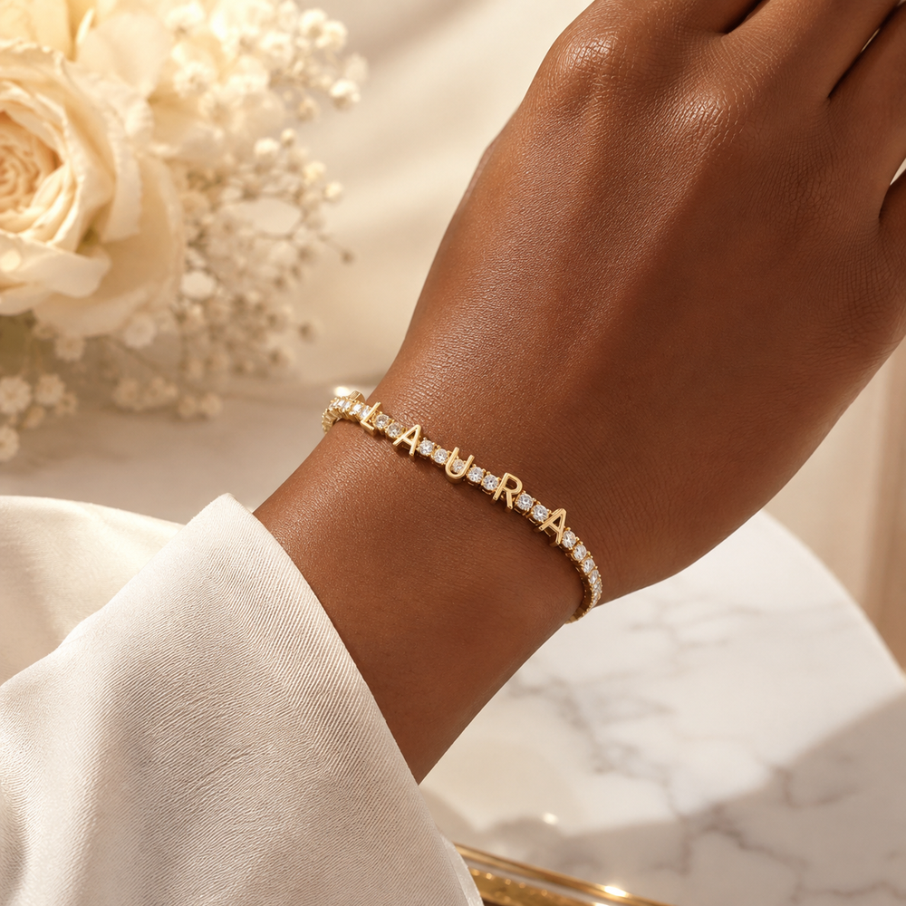 Personalized gold LAURA tennis bracelet worn on the wrist